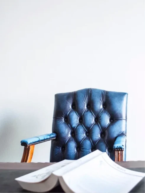 Blue leather office chair behind a desk with an open law book